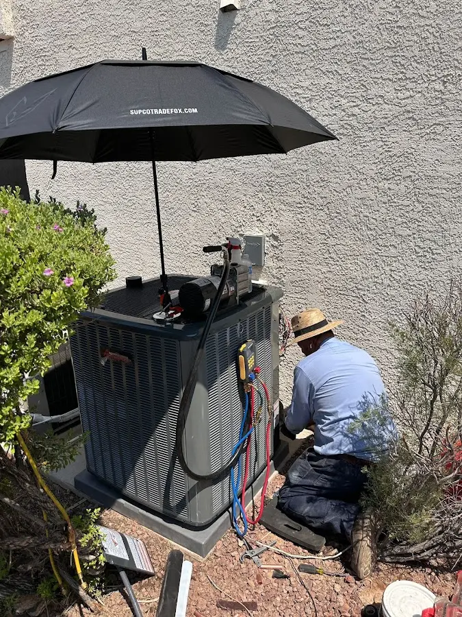 HVAC technician performing outdoor AC maintenance in Wilmore